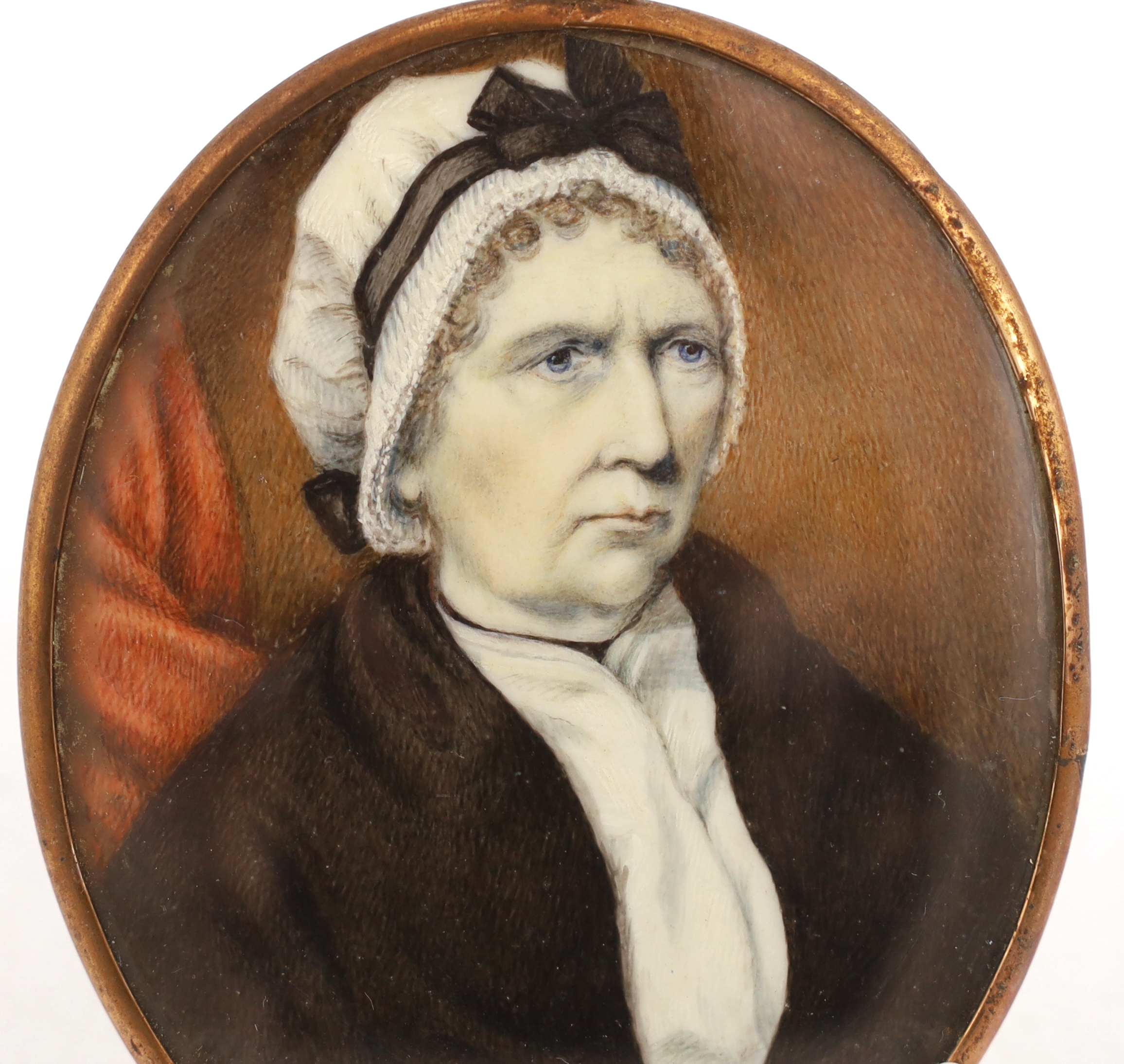 English School circa 1820, Portrait miniature of an elderly lady wearing a bonnet and brown shawl, watercolour on ivory, 8.5 x 7cm. CITES Submission reference UA96HZHB